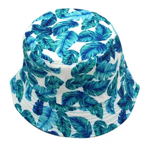 Unisex reversible bucket hat featuring blue tropical leaf prints on white canvas