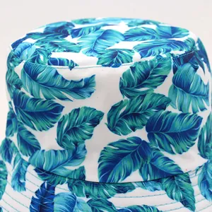 Unisex reversible bucket hat featuring tropical blue and green palm leaf print on canvas