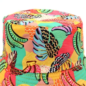 Reversible bucket hat with vibrant tropical banana and leaf print for sun protection