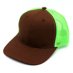Detail of brown cotton brim and neon green mesh panels on a stylish trucker cap
