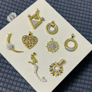 Gold-plated mermaid and heart pendants with zircon micro-paving on a white display board