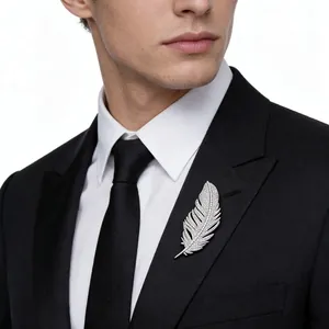 Elegant silver feather brooch with sparkling crystals on a black suit lapel
