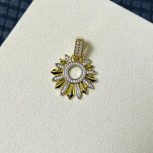 Macro detail of sun flower pendant with sparkling cubic zirconia and golden finish