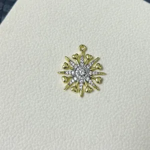 Macro shot of snowflake zircon pendant with gold heart details and center stone inlay