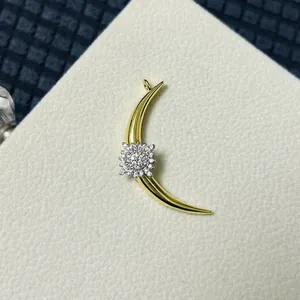 Detailed view of a golden crescent moon pendant featuring micro-paved zircon stars