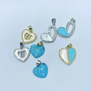 Macro view of assorted heart pendants with zircon pave, mother of pearl and enamel finish