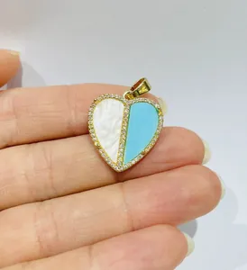 Close-up of heart pendant featuring white mother of pearl and blue turquoise inlay details