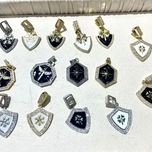 Macro view of enamel shield and hexagon pendants with micro-set zircon and star motifs