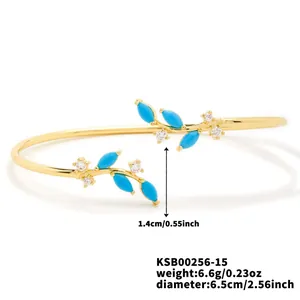 Detail view of gold willow branch bracelet with turquoise and zircon stones