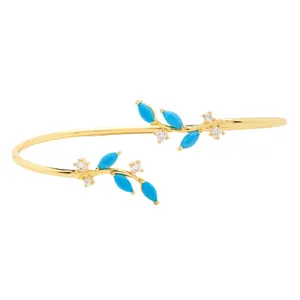 Minimalist gold vine open bangle with turquoise blue gems and small white crystals