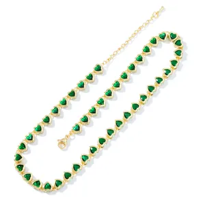 Detail of gold heart necklace with green zircon stones and adjustable lobster clasp closure