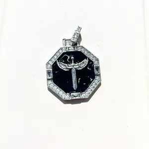 Detailed close-up of octagonal hip hop pendant with winged sword and micro-pave zircons
