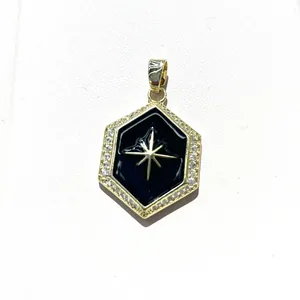 Macro detail of hexagonal pendant with black enamel star and cubic zirconia border