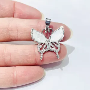 Silver butterfly necklace pendant with white shell wings and shimmering cubic zirconia crystals