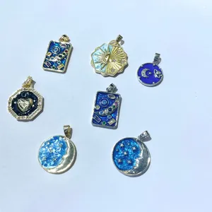 Celestial enamel pendant charms featuring sun and moon designs on gold and silver plating
