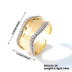Detail view of gold hammer textured wide open ring with dual rows of white cubic zirconia