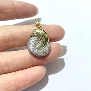 Two-tone gold plated pendant with cubic zirconia inlay shown on a white background