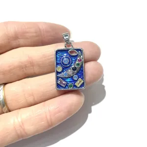 Starry sky pendant with blue enamel and colorful stones in a silver rectangle frame