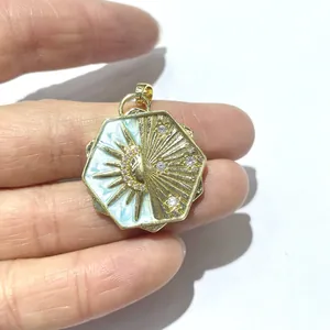 Macro detail of octagonal gold star and moon pendant with blue enamel and zircons