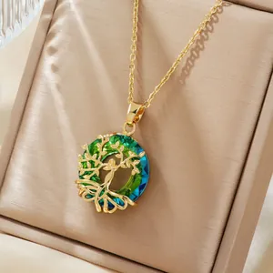 Detailed close-up of a golden Tree of Life pendant with gradient green and blue crystals