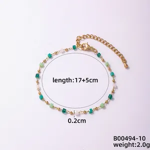 Detail showing 17+5cm adjustable length of golden bead bracelet with green glass stones