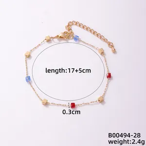 Detail view of gold beaded bracelet with red and blue glass beads showing 17+5cm length
