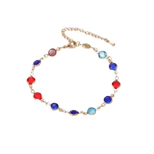 Elegant gold bracelet featuring colorful round and oval geometric glass stones and lobster clasp