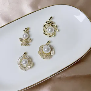 Luxurious pearl and zircon flower pendants set on champagne satin and gold rimmed plate