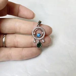 Dettaglio del ciondolo occhio del diavolo in argento con zirconi e perla di turchese