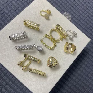 Detailed overhead view of multiple zircon studded earring sets in gold and silver finishes