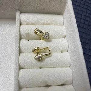 Detailed view of heart-shaped gold-plated hoop earrings featuring micro-pave cubic zirconia