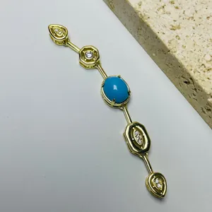 Elegant gold necklace pendant featuring turquoise stone and sparkling cubic zirconia gems