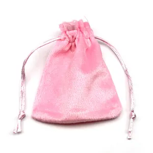 Macro view of a soft pink velvet drawstring jewelry pouch with satin ribbons for gifts