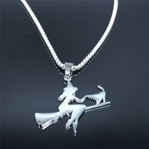 Polished stainless steel witch cat broom necklace on a reflective black surface