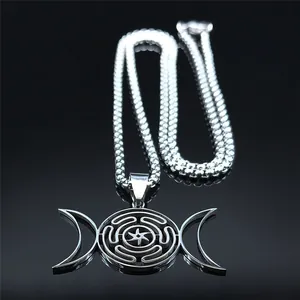 Macro detail of silver titanium steel Hecate's Wheel pendant with moon symbols on black glass