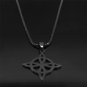 Detail of Celtic knot pendant with infinity design on a reflective black surface