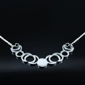 Silver stainless steel moon phase necklace featuring hollow crescent and full moon charms
