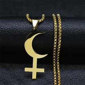Close-up of golden crescent moon and cross pendant on a bead chain necklace