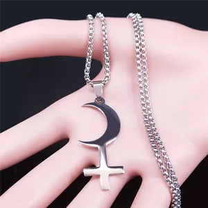 Macro view showing polished stainless steel crescent moon and cross pendant on box chain
