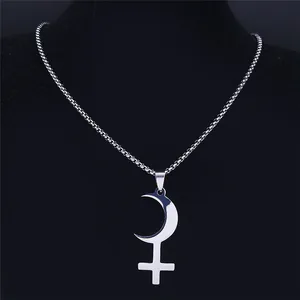 Vintage stainless steel silver crescent moon and cross pendant necklace on display