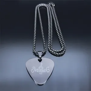 Macro detail of silver guitar pick pendant with music engraving and ball chain