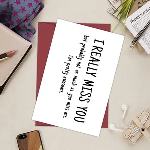 Funny birthday card with dark red envelope on a stylish desk with lifestyle accessories