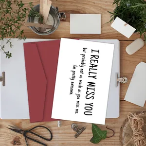 Close-up of funny greeting card with quote and envelope on minimalist desk setup