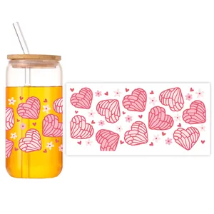 Detail of 16oz can glass featuring pink concha heart pattern with bamboo lid and straw