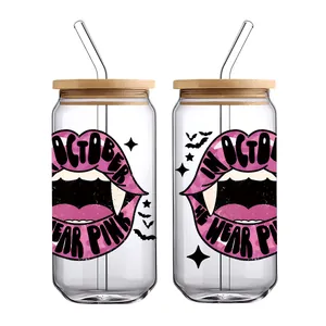 Detail view of 16oz can glasses with bamboo lids, straws, and pink breast cancer awareness print