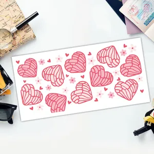 Detail of pink Concha heart stickers and floral decals on 16oz glass wrap sheet