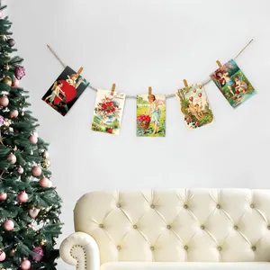 Vintage Cupid Valentine postcards hung with wooden clips and twine on a white wall