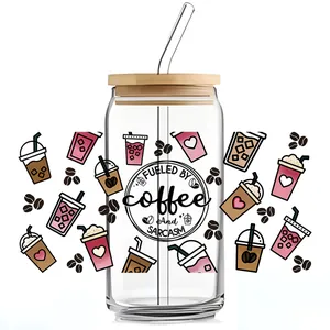 Detail of coffee themed UV DTF transfer on glass cup with bamboo lid and straw