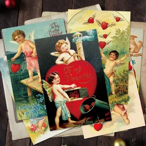 Macro shot of vintage Valentine's Day postcards with Cupid and Victorian heart illustrations