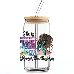 Detail of 16oz can glass with UV DTF transfer sticker featuring female illustration and quotes